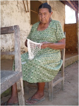 A Baure woman making a fisher net
