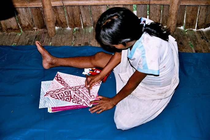 Woman drawing a weaving-design