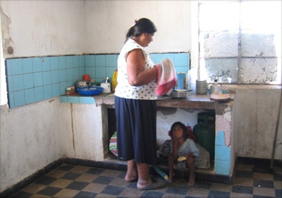 Angela Sistale working in the kitchen with one of her granddaughters. Qom Kayaripi community